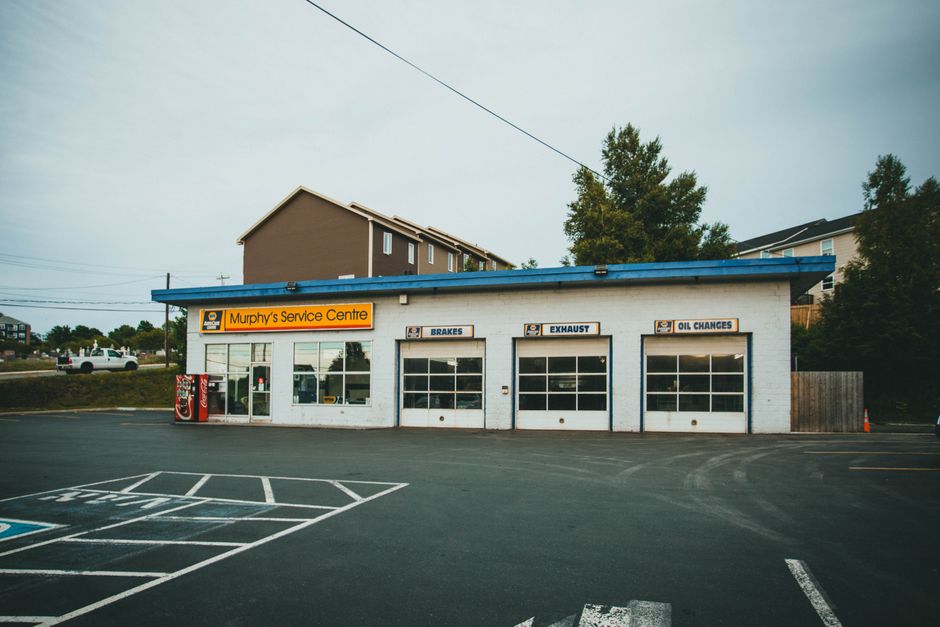 Exterior view of Murphy's Service Centre, showcasing workshop and spacious parking area.
