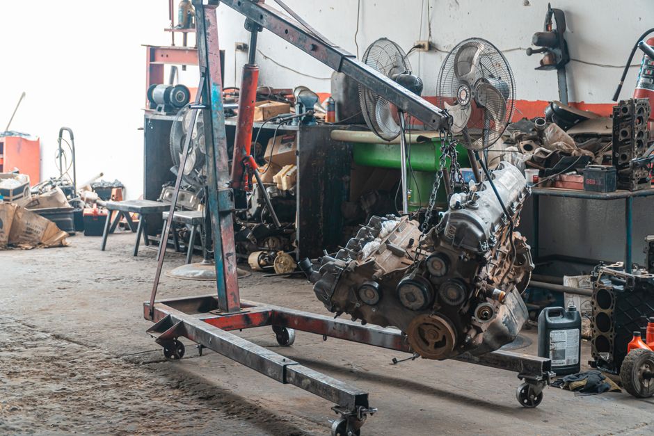 Detailed view of an engine lift in an industrial workshop setting.